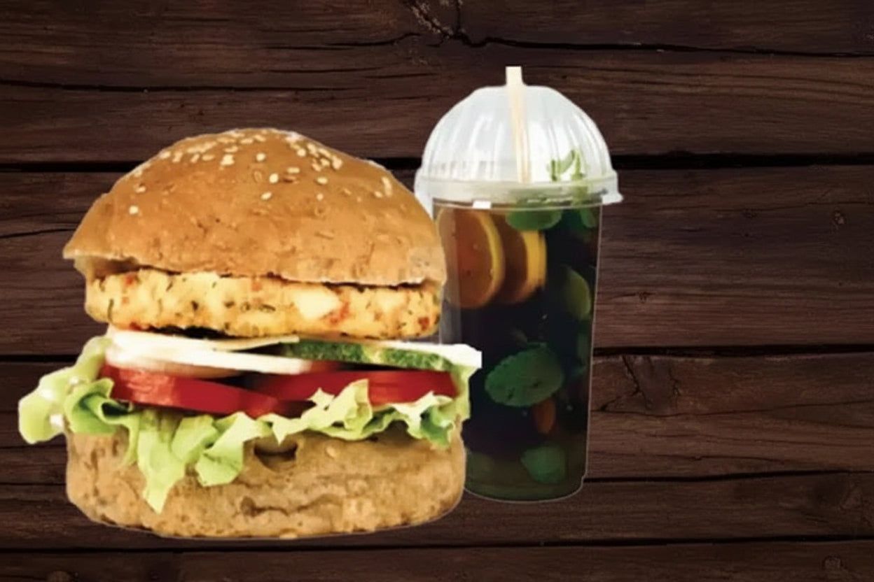 Hamburger with drink on a wooden surface