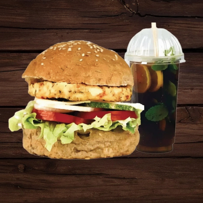 Hamburger with fries and a drink on a wooden surface